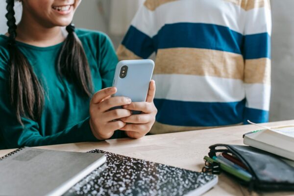Mädchen mit Smartphone und daneben eine andere Person